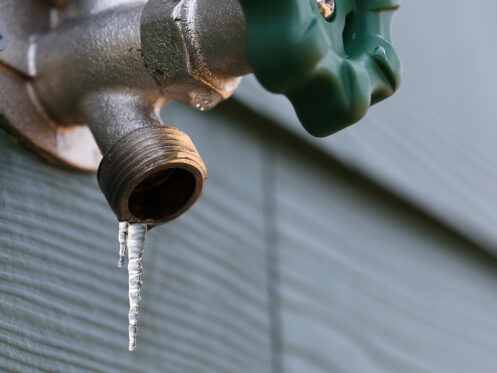 frozen exterior faucet with icicles hanging from the end